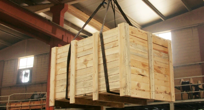 Wooden Shipping Crate being lifted in warehouse